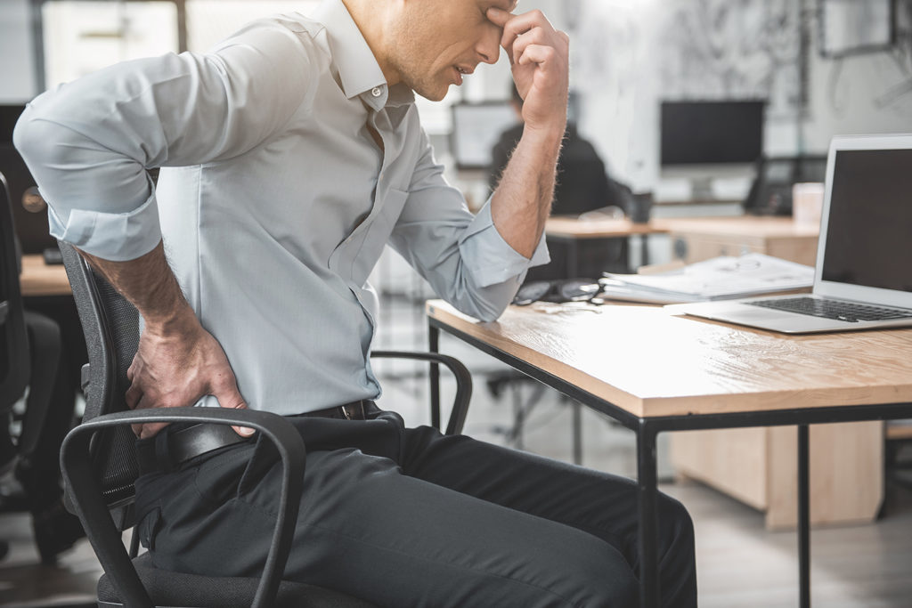man in office suffer pain pinched nerve