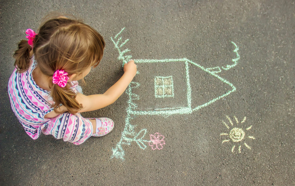 young girl making a graffiti in street floor