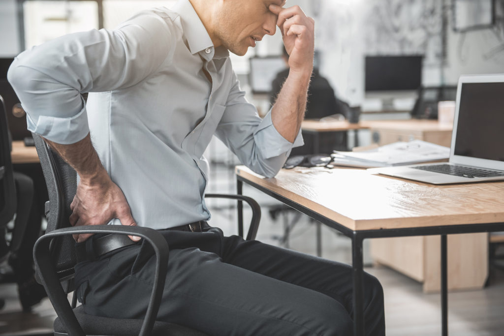 man suffer from lower back pain due to excessive sitting